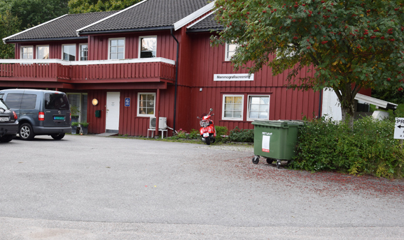 En motorsykkel parkert foran en r&oslash;d bygning